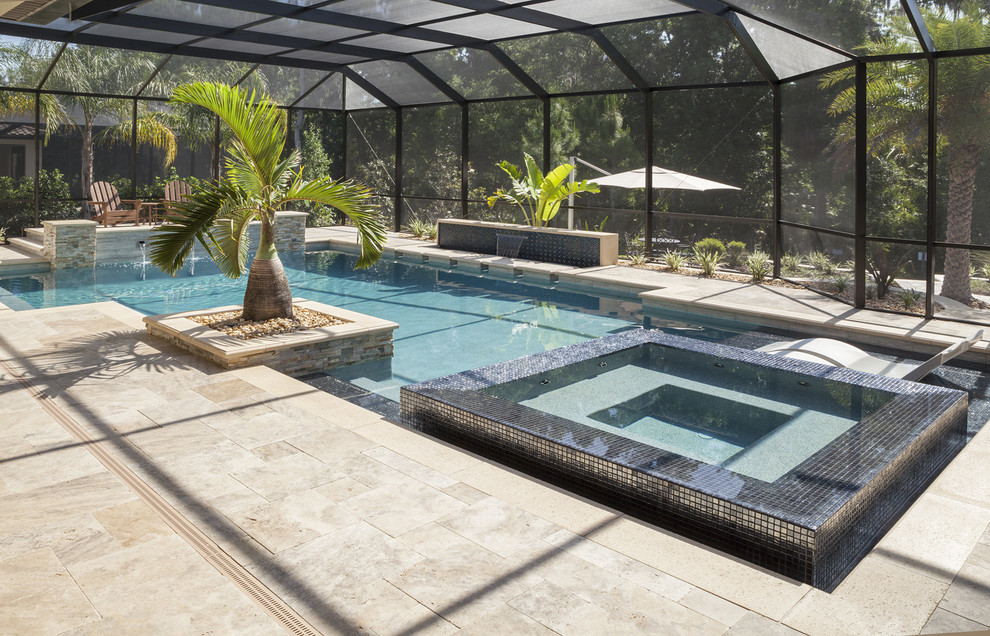 This is an example of a large contemporary indoor l-shaped lap pool in Tampa with a hot tub and tile.