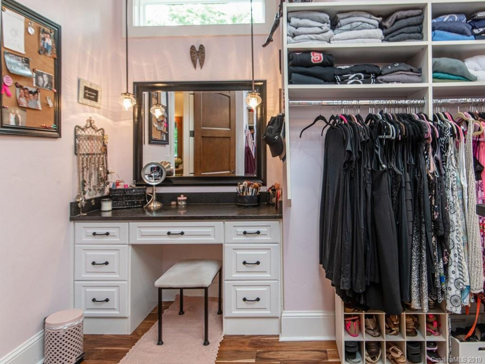Dressing room - large rustic women's dark wood floor dressing room idea