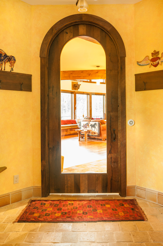 Inspiration for a mid-sized rustic concrete floor and beige floor front door remodel in Seattle with beige walls and a dark wood front door