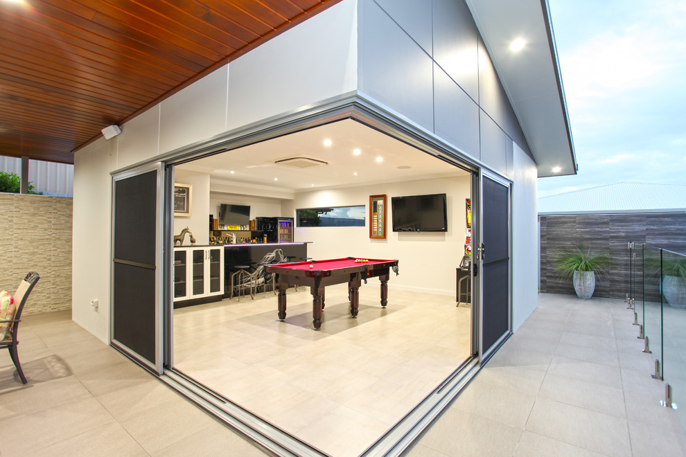 This is an example of a mid-sized contemporary single-wall seated home bar in Other with a drop-in sink, glass-front cabinets, black cabinets, quartz benchtops, black splashback, ceramic floors, grey floor and black benchtop.