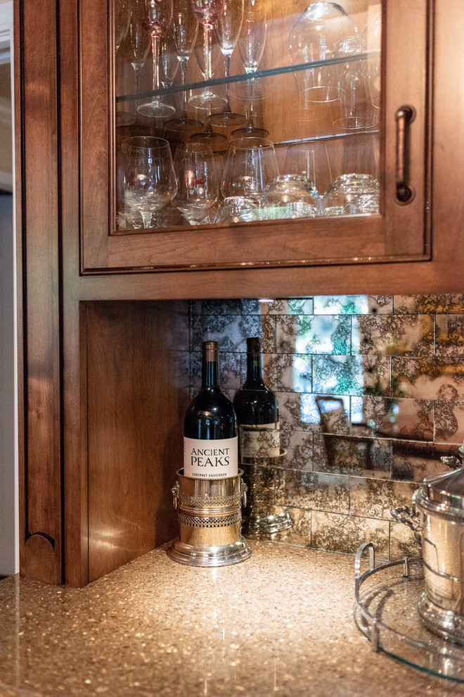 Design ideas for a mid-sized traditional single-wall home bar in San Luis Obispo with raised-panel cabinets, dark wood cabinets, quartz benchtops, mirror splashback, dark hardwood floors, brown floor and multi-coloured benchtop.