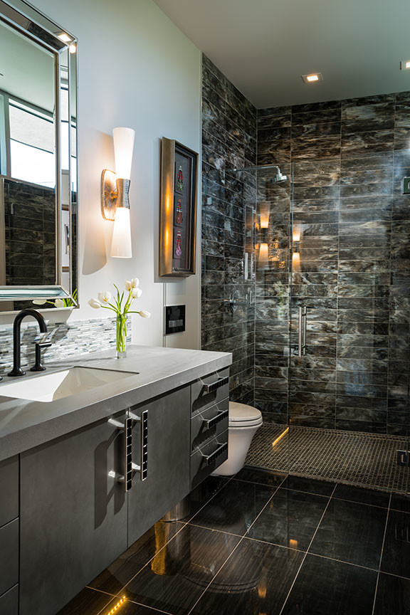 Photo of an expansive contemporary 3/4 bathroom in Other with flat-panel cabinets, brown cabinets, an alcove shower, stone tile, an undermount sink, quartzite benchtops, grey floor, a hinged shower door and white benchtops.