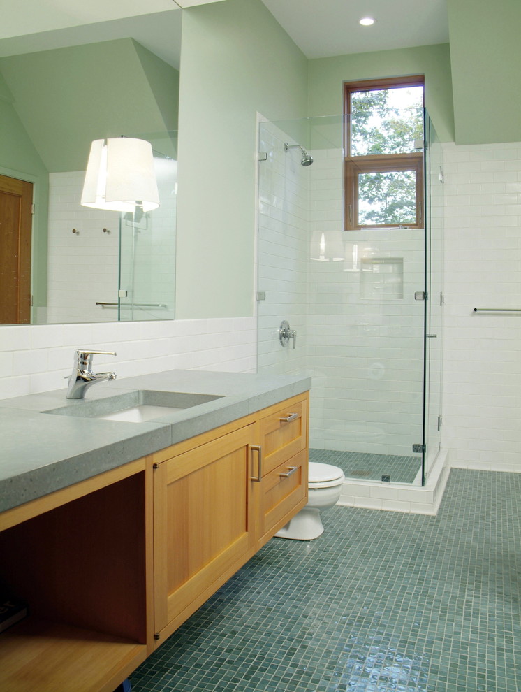 Photo of a large country master bathroom in Burlington with mosaic tile, blue tile, concrete benchtops, blue floor, recessed-panel cabinets, light wood cabinets, a corner shower, a two-piece toilet, green walls, an undermount sink, a hinged shower door and green benchtops.