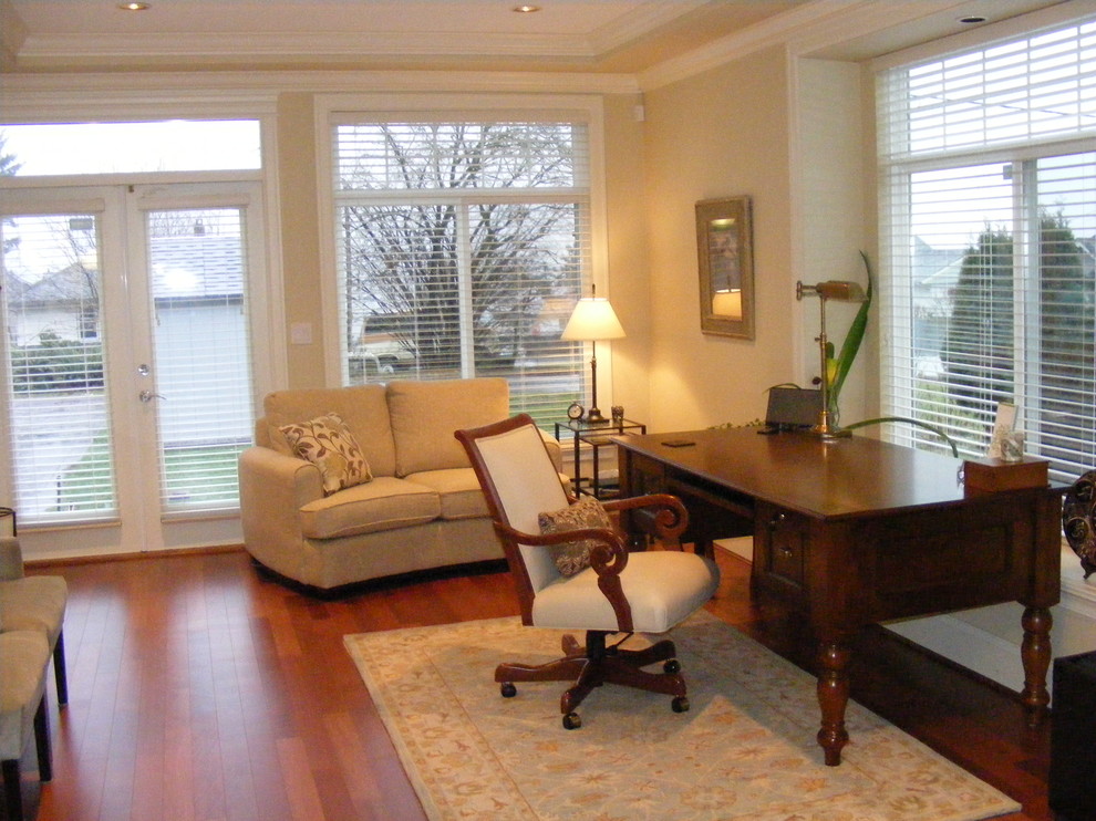 Photo of a large traditional study room in Vancouver with medium hardwood floors and a freestanding desk.