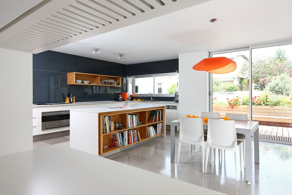 Small modern l-shaped eat-in kitchen in Tel Aviv with open cabinets, white cabinets, blue splashback, glass sheet splashback, stainless steel appliances, a drop-in sink, quartz benchtops, limestone floors and with island.