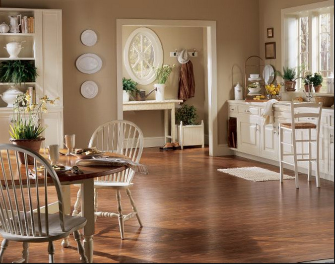 Example of a mid-sized farmhouse single-wall vinyl floor eat-in kitchen design in Charleston with an undermount sink, raised-panel cabinets, white cabinets, solid surface countertops and no island