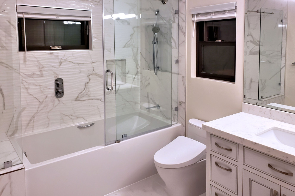 Mid-sized contemporary kids bathroom in San Francisco with recessed-panel cabinets, white cabinets, an alcove tub, a shower/bathtub combo, a bidet, white tile, porcelain tile, white walls, porcelain floors, an undermount sink, quartzite benchtops, white floor, a sliding shower screen and multi-coloured benchtops.