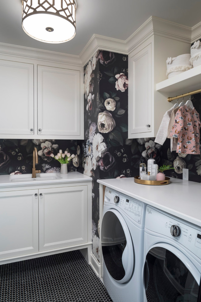 Design ideas for a transitional dedicated laundry room in Minneapolis with an undermount sink, shaker cabinets, white cabinets, quartzite benchtops, multi-coloured walls, ceramic floors, a side-by-side washer and dryer, black floor, white benchtop and wallpaper.