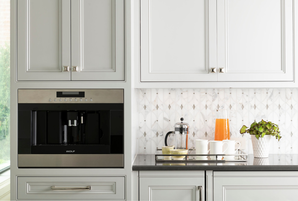 Inspiration for a huge transitional single-wall kitchen remodel in Dallas with flat-panel cabinets, gray cabinets, quartz countertops, white backsplash, marble backsplash, stainless steel appliances and gray countertops