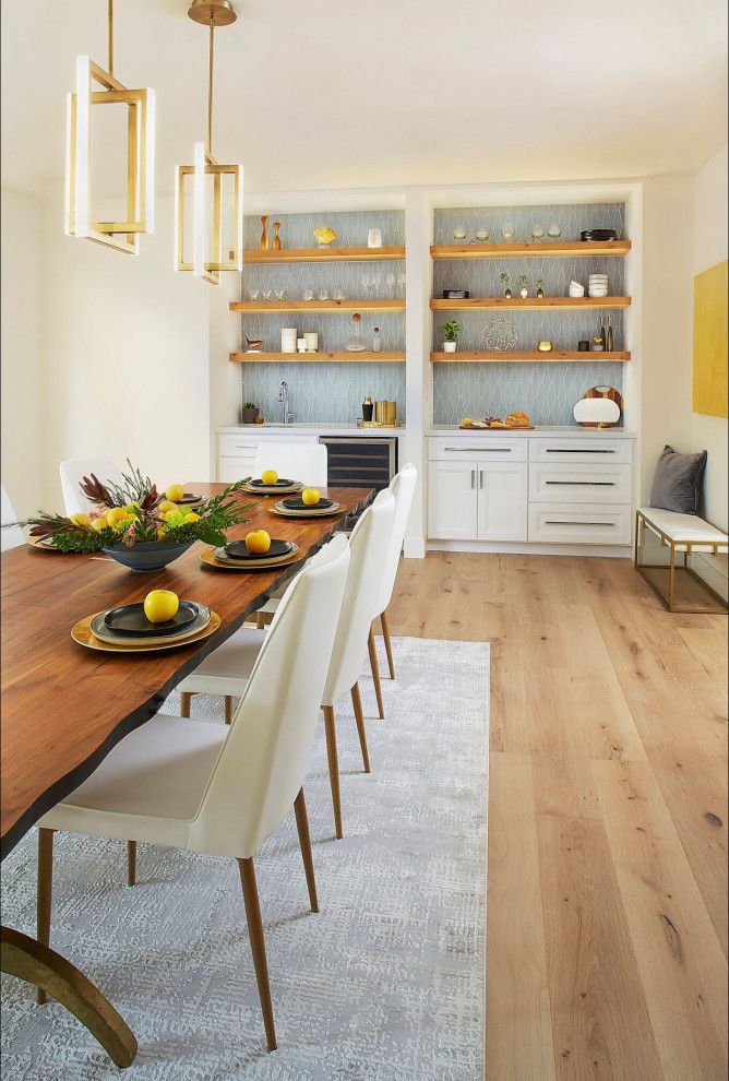 Inspiration for a large transitional kitchen/dining combo in San Francisco with white walls, light hardwood floors, a corner fireplace, a plaster fireplace surround and white floor.