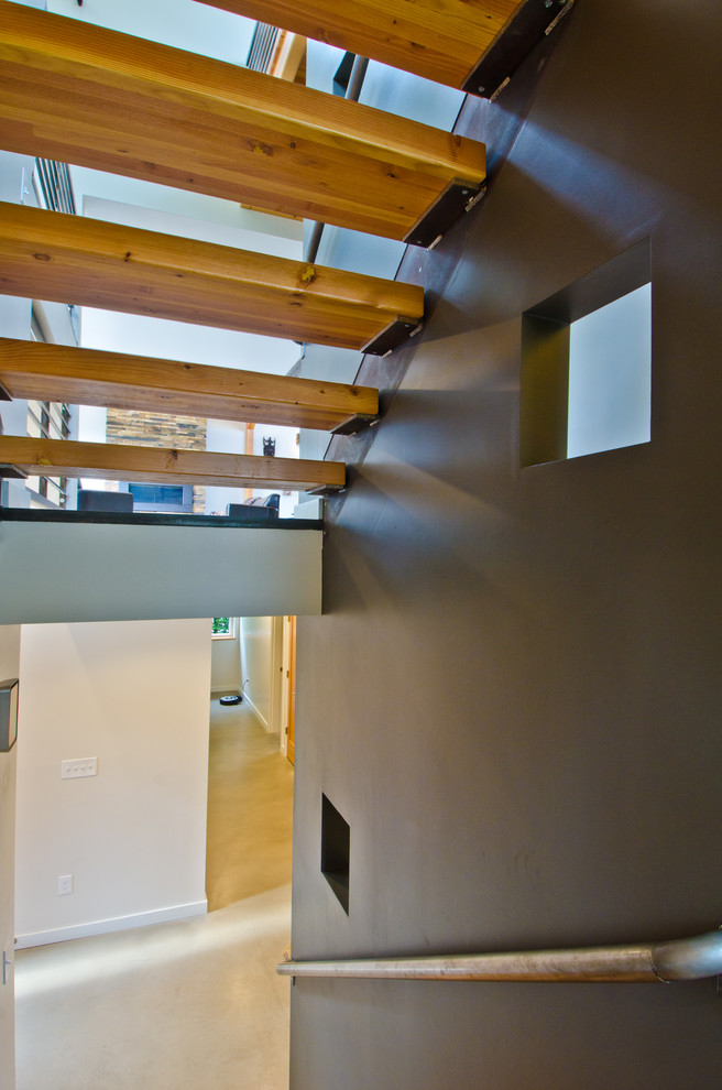 Inspiration for a mid-sized modern wood u-shaped staircase in Seattle with open risers.