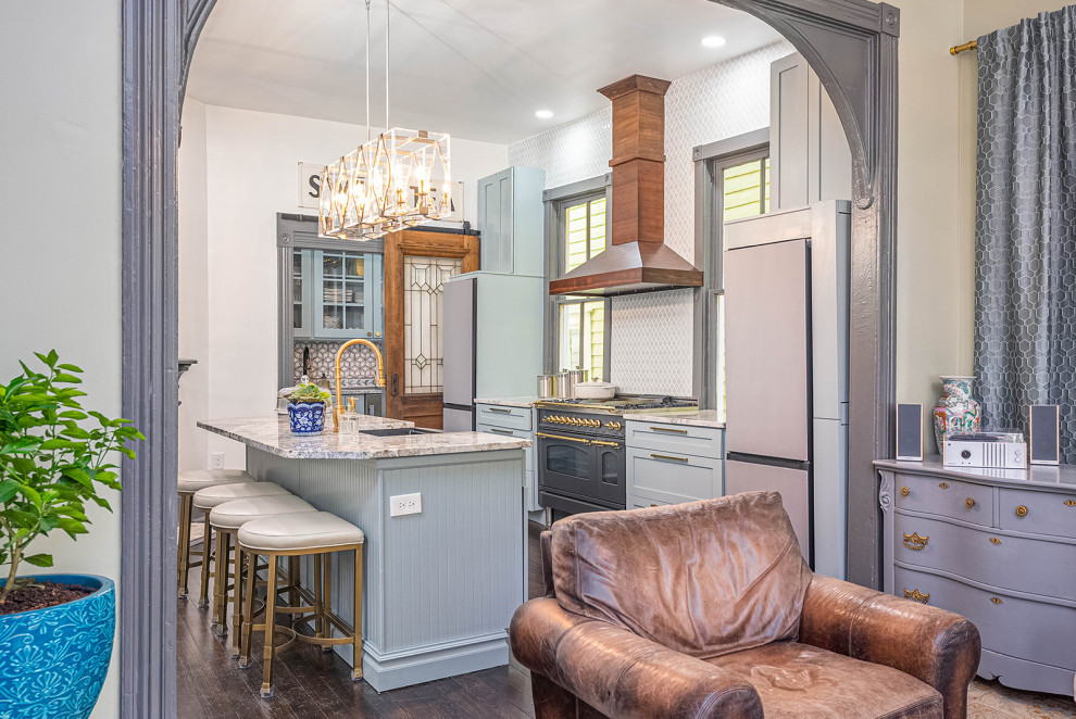 Inspiration for a large transitional galley dark wood floor and black floor eat-in kitchen remodel with a single-bowl sink, shaker cabinets, blue cabinets, granite countertops, blue backsplash, ceramic backsplash, black appliances, an island and white countertops