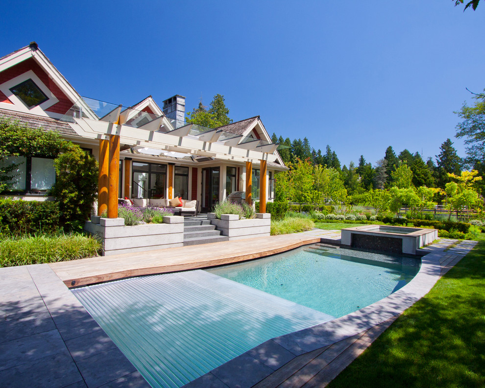 Example of a transitional backyard custom-shaped hot tub design in Vancouver