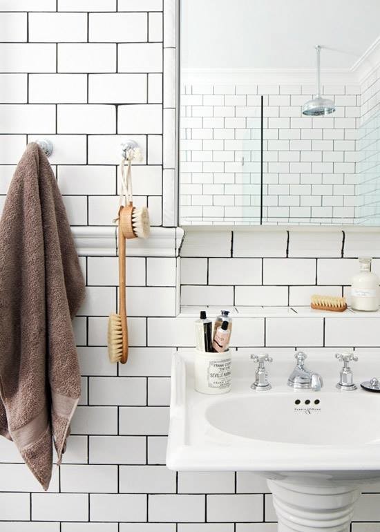 Corner shower - mid-sized transitional 3/4 white tile and subway tile corner shower idea in Milwaukee with white walls and a pedestal sink