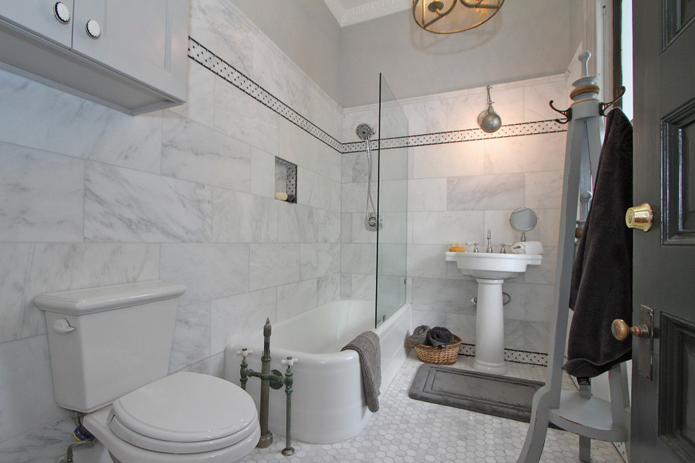 Design ideas for a large contemporary bathroom in Charleston with ceramic floors, recessed-panel cabinets, grey cabinets, a corner tub, a shower/bathtub combo, a two-piece toilet and a pedestal sink.
