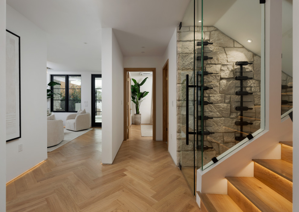 Example of a mid-sized trendy light wood floor wine cellar design in Orange County