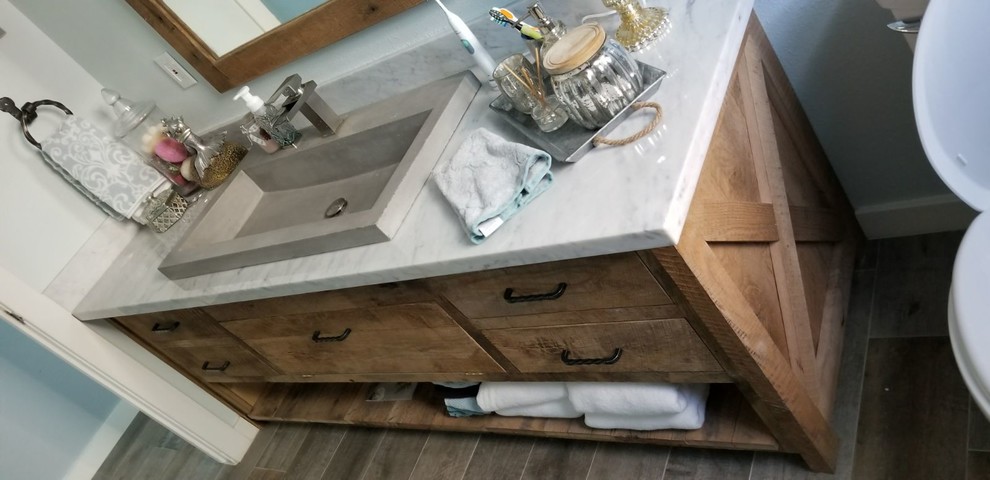 Example of a small mountain style 3/4 beige tile bathroom design in Houston with light wood cabinets and quartzite countertops