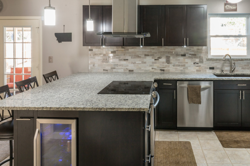 Example of a mid-sized u-shaped ceramic tile and beige floor eat-in kitchen design with an undermount sink, shaker cabinets, black cabinets, granite countertops, glass tile backsplash, stainless steel appliances, an island and white countertops