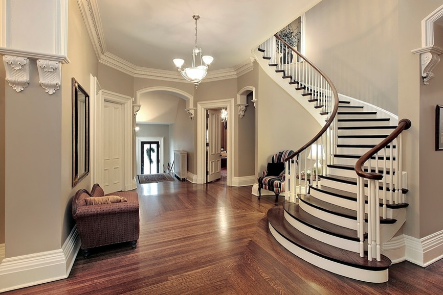 This is an example of a mid-sized traditional wood curved staircase in New Orleans with painted wood risers.