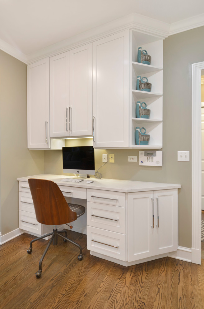 Mid-sized transitional single-wall medium tone wood floor open concept kitchen photo in Chicago with an undermount sink, shaker cabinets, white cabinets, quartz countertops, gray backsplash, ceramic backsplash, stainless steel appliances, an island and white countertops