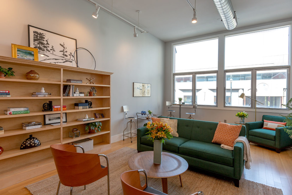 Small trendy formal and open concept light wood floor and brown floor living room photo in Portland Maine with white walls and no fireplace