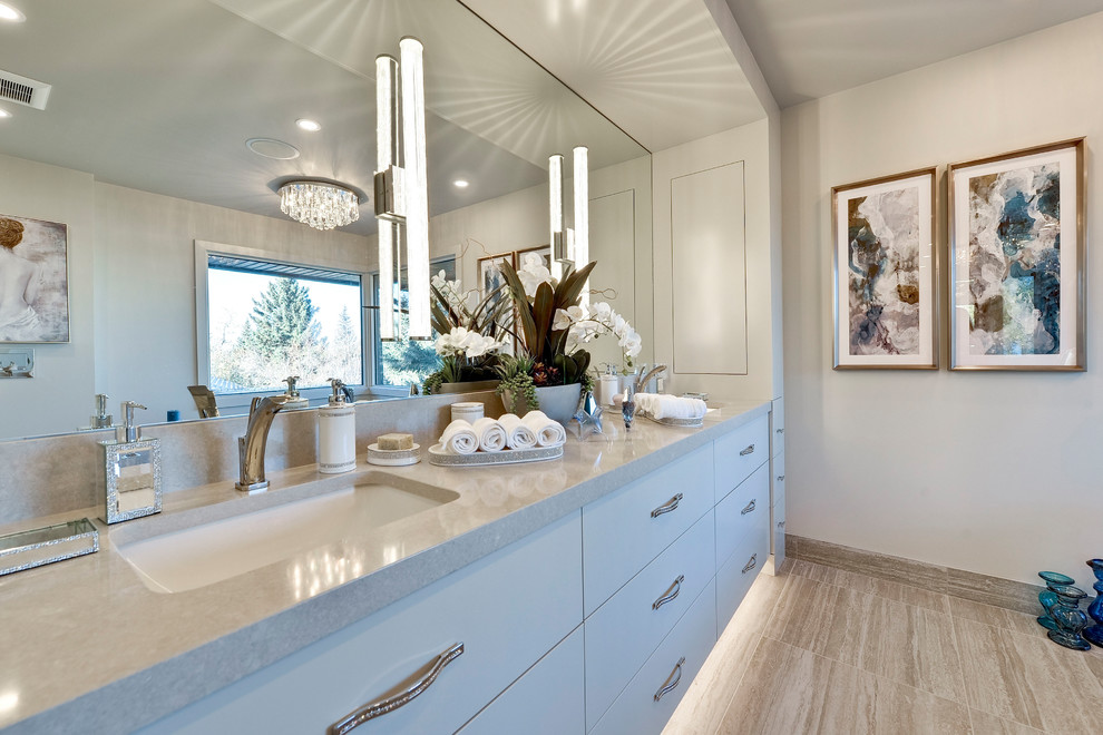 This is an example of a large transitional master bathroom in Calgary with flat-panel cabinets, white cabinets, an alcove shower, a two-piece toilet, beige walls, porcelain floors, an undermount sink, beige floor, a hinged shower door and beige benchtops.