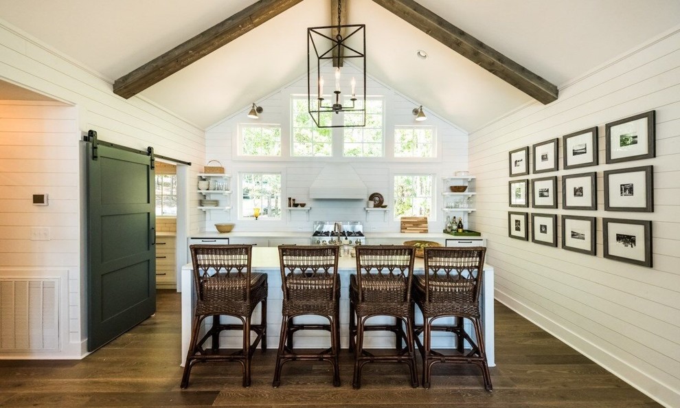 Example of a mid-sized cottage galley medium tone wood floor and brown floor enclosed kitchen design in Atlanta with an island, shaker cabinets, white cabinets, stainless steel appliances, a farmhouse sink, marble countertops, white backsplash and wood backsplash