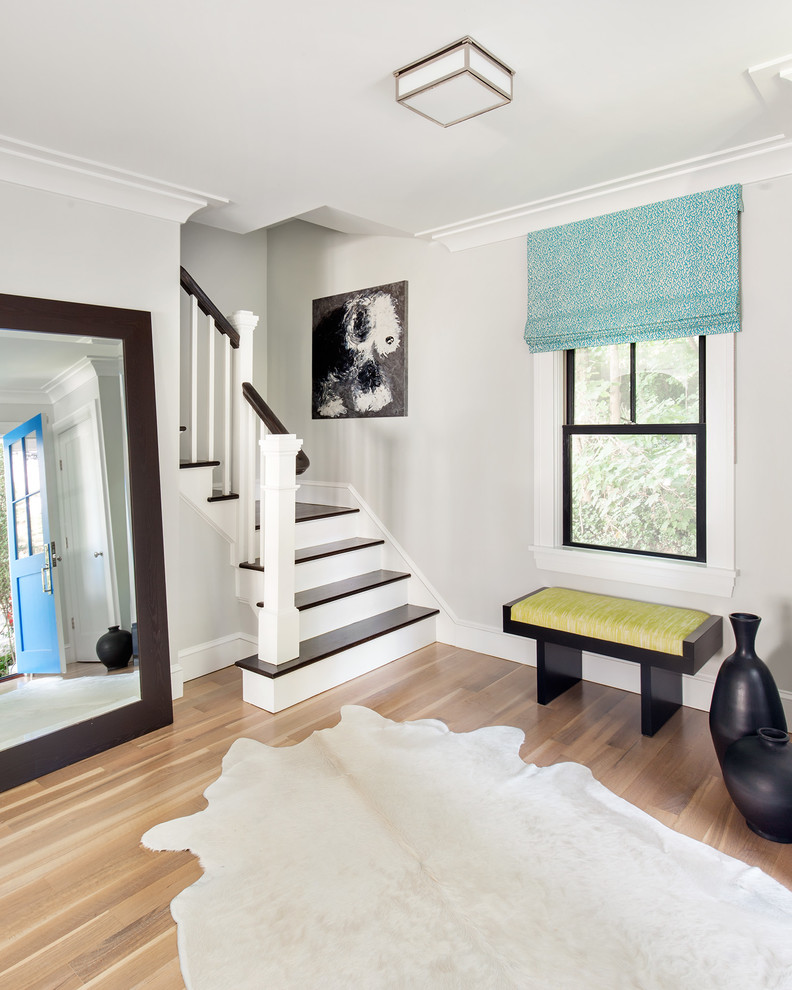 Inspiration for a transitional foyer in New York with grey walls and medium hardwood floors.