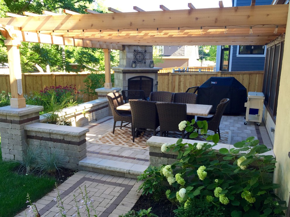 Photo of a contemporary backyard patio in Chicago with brick pavers and a pergola.