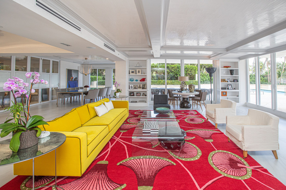 Contemporary open plan living room in Miami with white walls, white floors and a coffered ceiling.