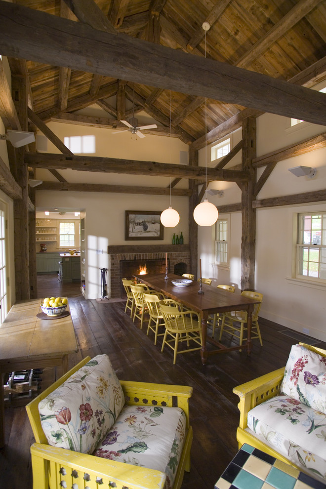 Country dining room in New York with beige walls and dark hardwood floors.