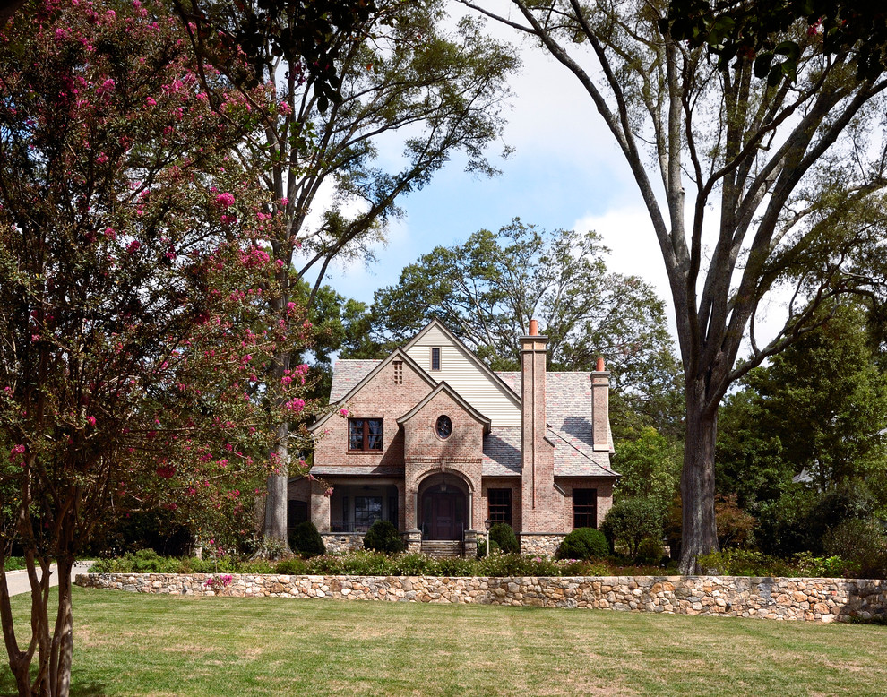Design ideas for a traditional three-storey brick exterior in Jacksonville with a gable roof.