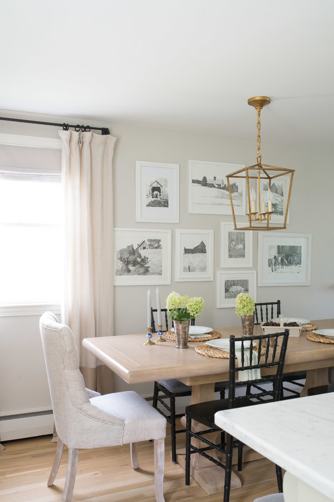 Inspiration for a mid-sized transitional kitchen/dining combo in Boston with light hardwood floors and brown floor.