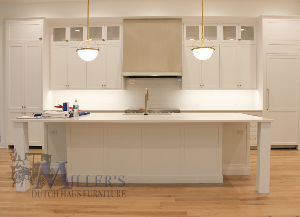 Inspiration for a large transitional l-shaped open plan kitchen in Tampa with a drop-in sink, shaker cabinets, white cabinets, with island and beige floor.