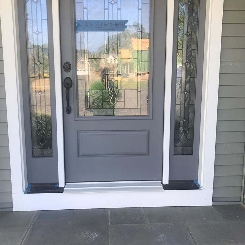 Example of a front door design in Bridgeport with a gray front door