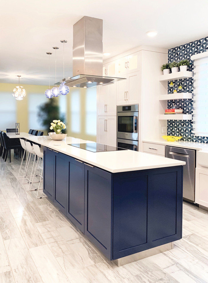 This is an example of a large modern u-shaped kitchen pantry in Other with a farmhouse sink, shaker cabinets, yellow cabinets, quartz benchtops, blue splashback, glass tile splashback, stainless steel appliances, porcelain floors, with island, grey floor and white benchtop.