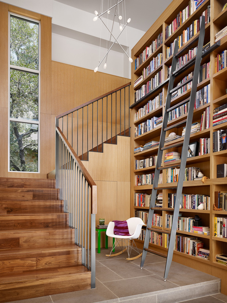 Contemporary wood l-shaped staircase in Austin with wood risers and metal railing.