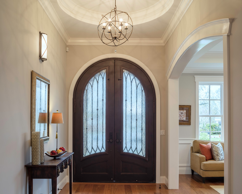 Photo of a mid-sized transitional foyer in San Francisco with grey walls, medium hardwood floors, a double front door and a dark wood front door.