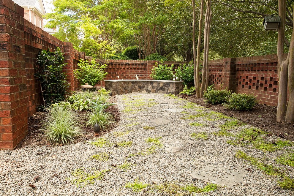 Photo of a small contemporary backyard shaded garden in Charlotte with a garden path and gravel.