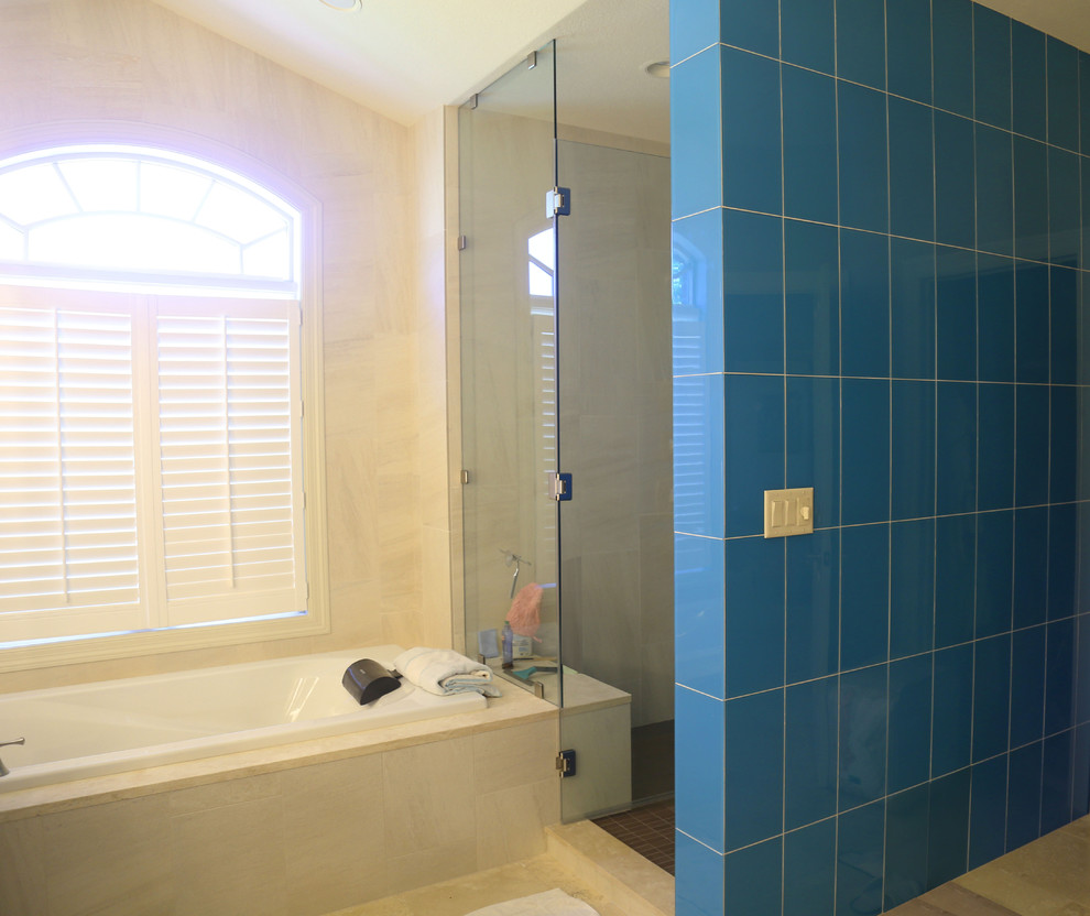 Mid-sized transitional master white tile and porcelain tile porcelain tile drop-in bathtub photo with raised-panel cabinets, white cabinets, a two-piece toilet, white walls, an undermount sink and granite countertops