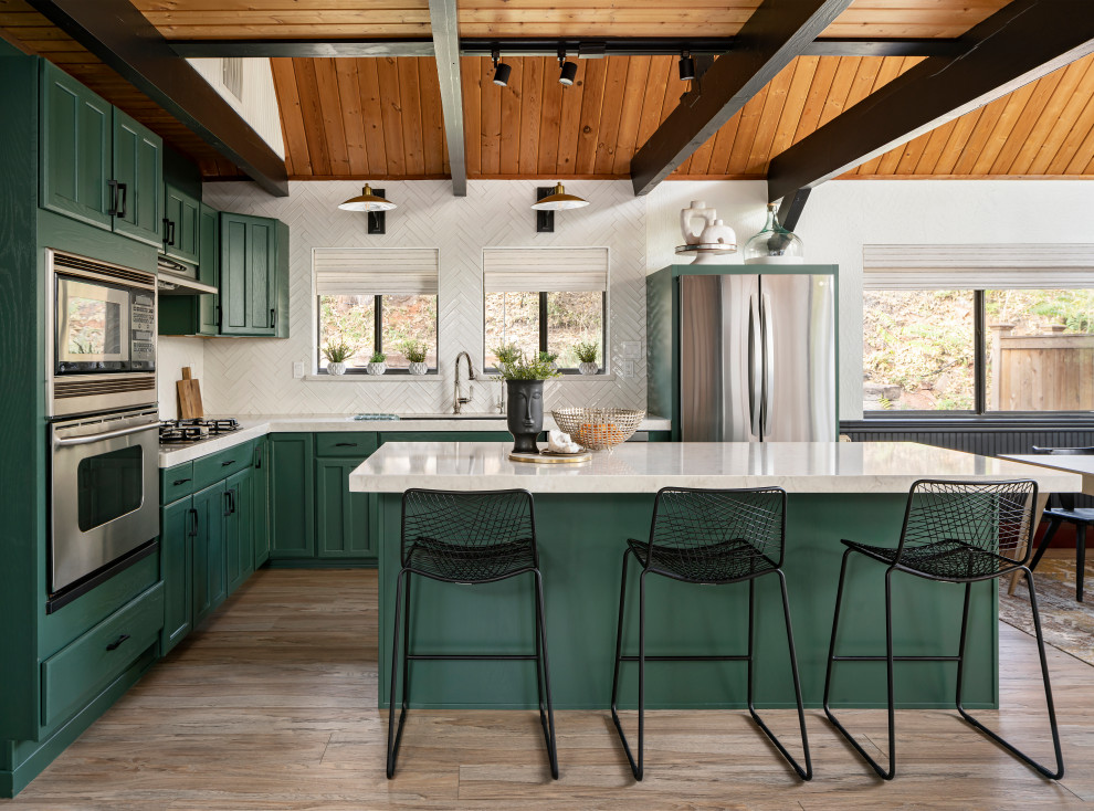 Example of a small mountain style l-shaped light wood floor, beige floor, wood ceiling and vaulted ceiling open concept kitchen design in Phoenix with an undermount sink, recessed-panel cabinets, green cabinets, quartz countertops, white backsplash, subway tile backsplash, stainless steel appliances, an island and white countertops