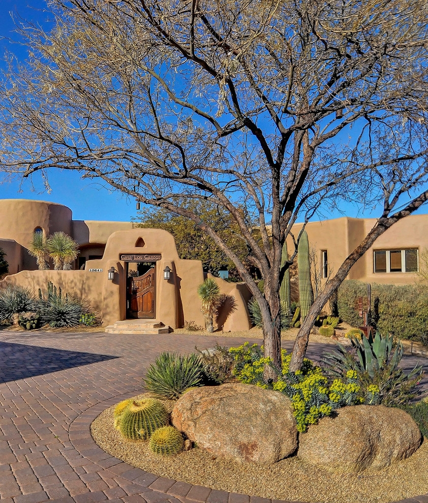 Inspiration for a front yard driveway in Phoenix with concrete pavers.