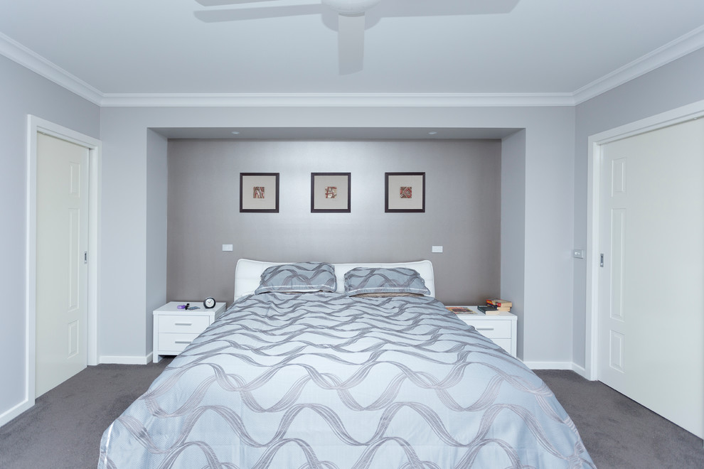 Mid-sized transitional master bedroom in Melbourne with grey walls, carpet, no fireplace and grey floor.