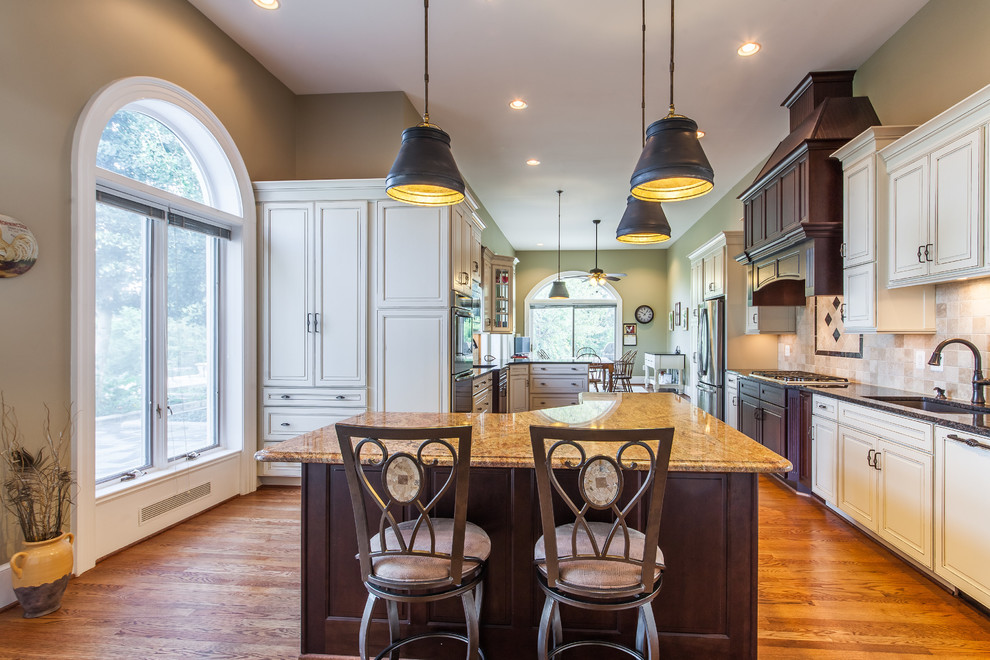 Inspiration for a huge transitional medium tone wood floor eat-in kitchen remodel in DC Metro with raised-panel cabinets, granite countertops, stainless steel appliances and an island