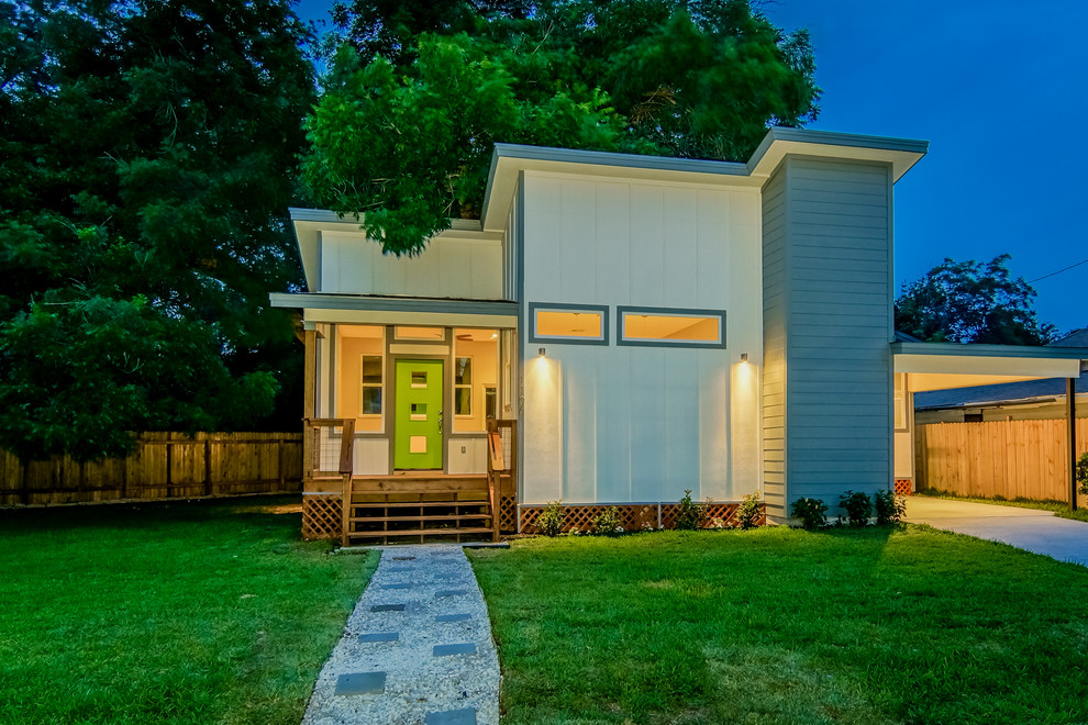 This is an example of a small modern one-storey white exterior in Austin with wood siding.