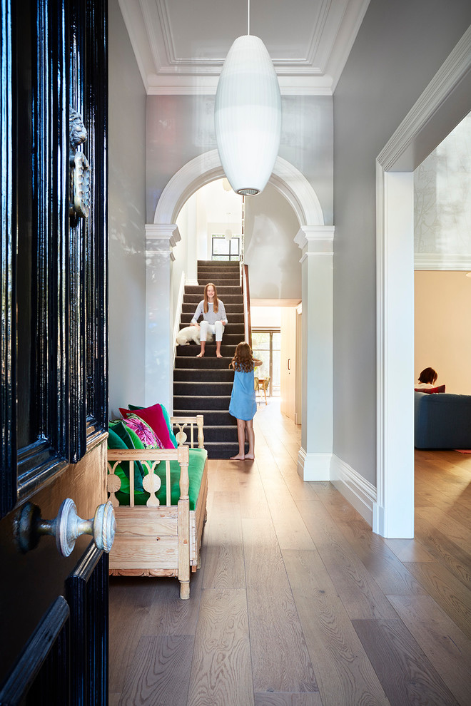 Inspiration for a traditional entryway in Melbourne with grey walls and medium hardwood floors.