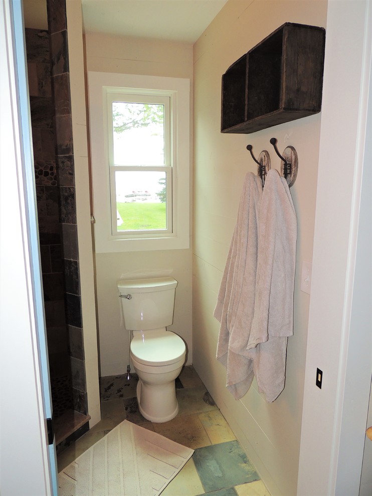 Photo of a small country 3/4 bathroom in Other with furniture-like cabinets, a corner shower, slate, slate floors, wood benchtops and a hinged shower door.