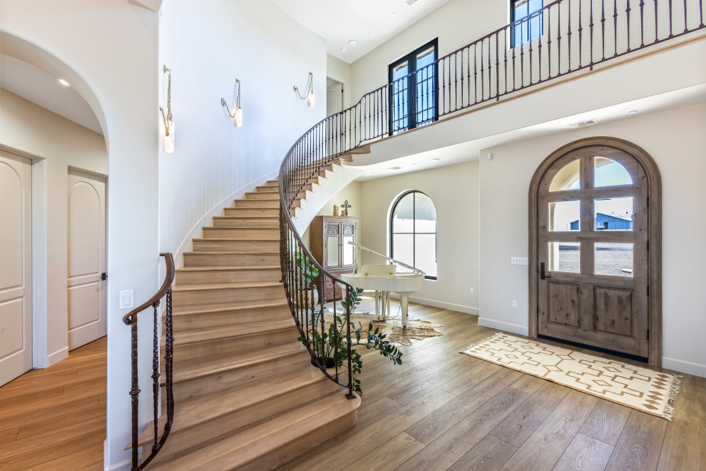 Great Room Curved Staircase and Windows | Tuscan Farmhouse