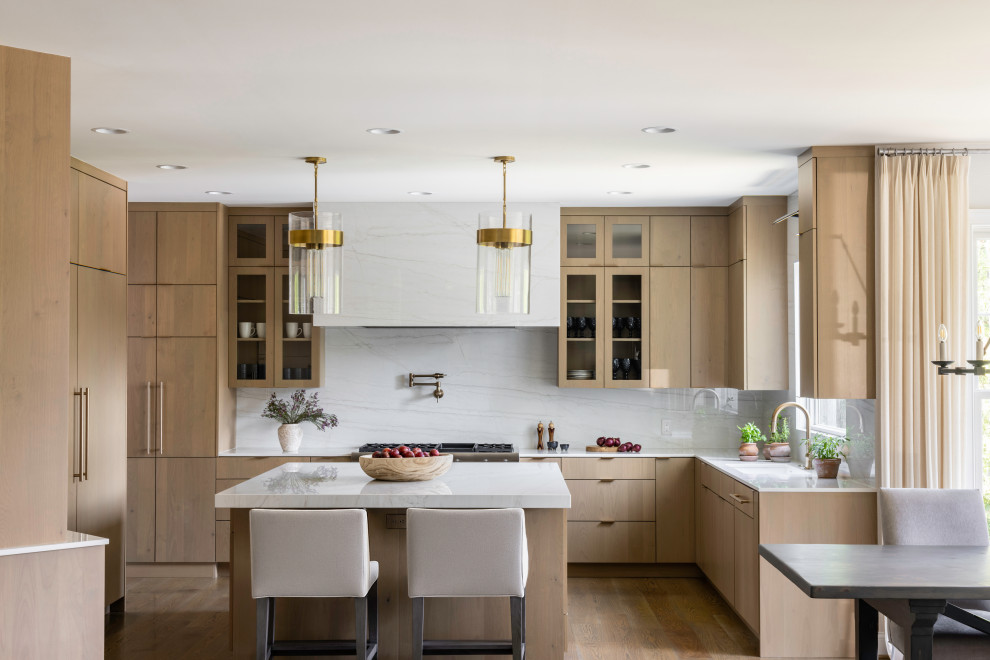 Open concept kitchen - large contemporary u-shaped light wood floor open concept kitchen idea in DC Metro with an undermount sink, flat-panel cabinets, light wood cabinets, quartz countertops, white backsplash, quartz backsplash, paneled appliances, an island and white countertops