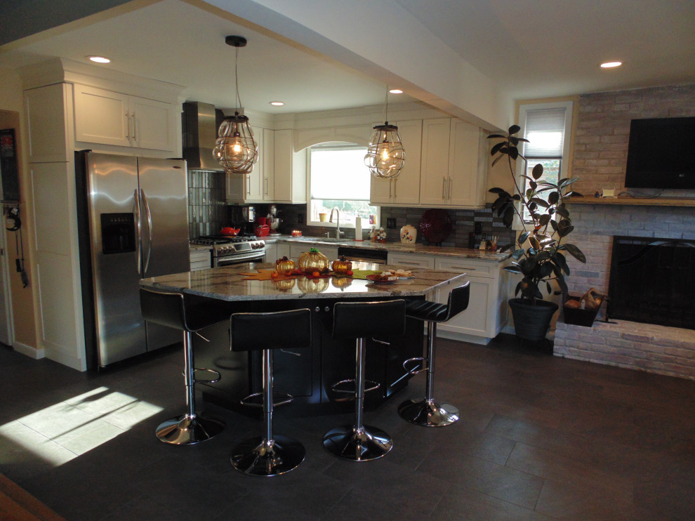 Eat-in kitchen - small transitional l-shaped ceramic tile and brown floor eat-in kitchen idea with an undermount sink, recessed-panel cabinets, white cabinets, quartz countertops, gray backsplash, subway tile backsplash, stainless steel appliances, an island and gray countertops